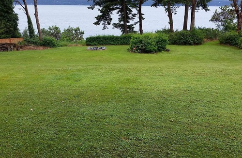 Camano Island House | Awesome sunsets, kayaks, firepit, hot tub, big fenced lawn, crab boat and buoy!