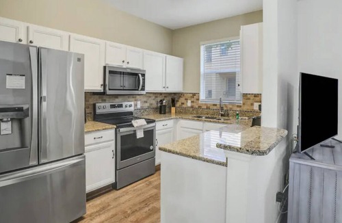 Regal Palms Villa | Resort townhome with patio, on-site pool and hot tub, gym, pool table, AC & W/D