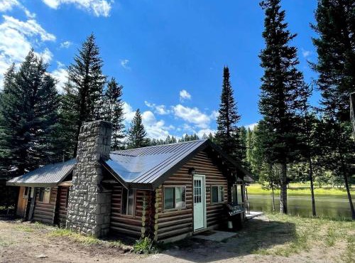 Charming Riverfront Cabin with Hot Tub and Dock Access Near Scenic Trails in Island Park, Idaho in Island Park