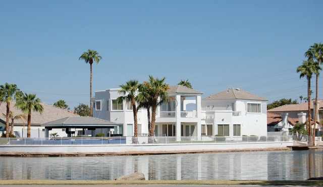 This GORGEOUS custom home is located on 3/4 acre waterfront in Gilbert Arizona in Gilbert